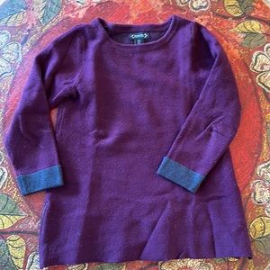 Purple and gray long cut sweater with zippers at side bottom.